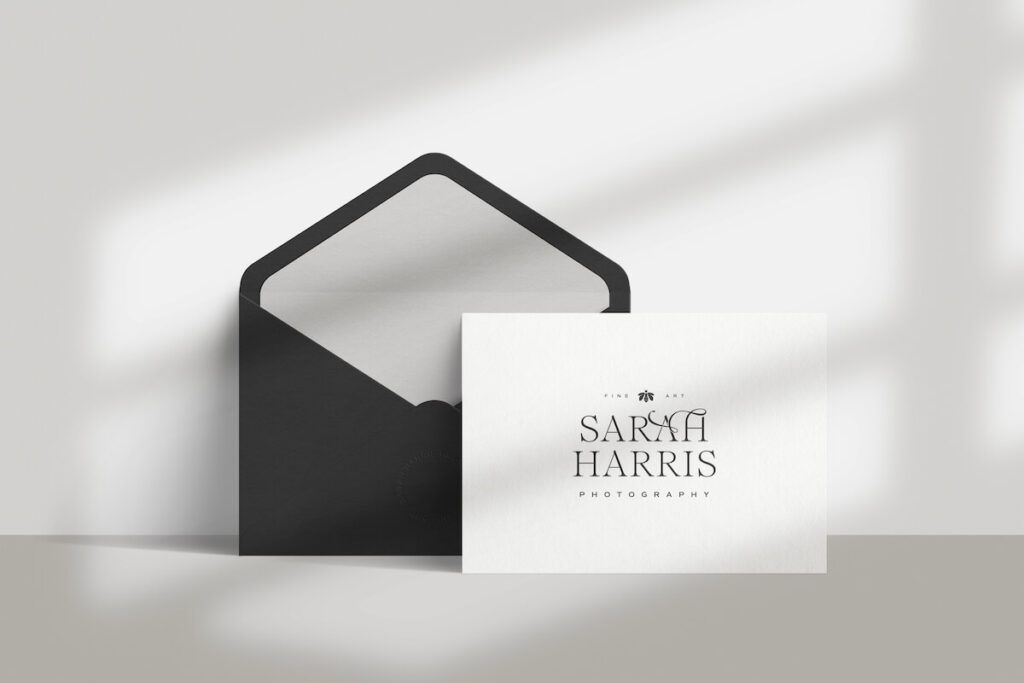 A mockup of a stationery card featuring a classic feminine logo, designed with a sleek serif font and custom flourishes.